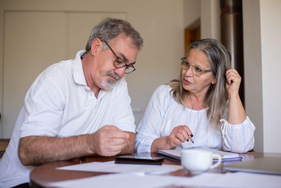 Older couple reviewing financial documents together at home